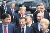 U.S. President Donald Trump (L) and President Recep Tayyip Erdoğan (R) follow other leaders to a “family photo “during the summit at NATO headquarters, Brussels, July 11.
